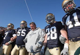 SOUTH BEND, IN - NOVEMBER 21: Head coach Charlie Weis of the Notre Dame Fighting Irish waits to enter the field with (L-R) Jimmy Clausen #7, Eric Olsen #55, Kyle McCarthy #28 and Scott Smith #41 before a game against the University of Connecticut Huskies at Notre Dame Stadium on November 21, 2009 in South Bend, Indiana. (Photo by Jonathan Daniel/Getty Images)