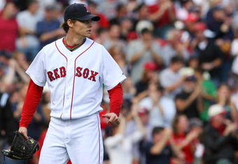 BOSTON - OCTOBER 11:  Clay Buchholz #61 of the Boston Red Sox looks on from the mound in the second inning against the Los Angeles Angels of Anaheim in Game Three of the ALDS during the 2009 MLB Playoffs at Fenway Park on October 11, 2009 in Boston,  Massachusetts. (Photo by Jim Rogash/Getty Images)