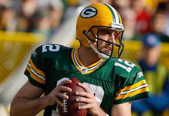GREEN BAY, WI - NOVEMBER 22: Quarterback Aaron Rodgers #12 of the Green Bay Packers passes the football against the San Francisco 49ers at Lambeau Field on November 22, 2009 in Green Bay, Wisconsin. The Packers defeated the 49ers 30-24. (Photo by Scott Boehm/Getty Images)