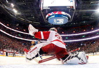 MONTREAL- NOVEMBER 21:  Jimmy Howard #35 of the Detroit Red Wings stretches out to stop the puck on the shootout attempt by Mike Cammalleri #13 of the Montreal Canadiens during the NHL game on November 21, 2009 at the Bell Centre in Montreal, Quebec, Canada.  The Red Wings defeated the Canadiens 3-2 in a shootout.  (Photo by Richard Wolowicz/Getty Images)
