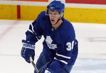 LONDON, ON - SEPTEMBER 17:  Carl Gunnarsson #36 of the Toronto Maple Leafs skates with the puck in a pre-season game against the Philadelphia Flyers on September 17, 2009 at the John Labatt Centre in London, Ontario. The Leafs defeated the Flyers 4-0. (Photo by Claus Andersen/Getty Images)