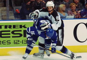 TORONTO - DECEMBER 3:  Tomas Kaberle #15 of the Toronto Maple Leafs checks Vincent Lecavalier #4 of the Tampa Bay Lightning as he tries to reach the puck during the NHL game at Air Canada Centre on December 3, 2002 in Toronto, Ontario. The Maple Leafs defeated the Lightning 4-3. (Photo By Dave Sandford/Getty Images/NHLI)