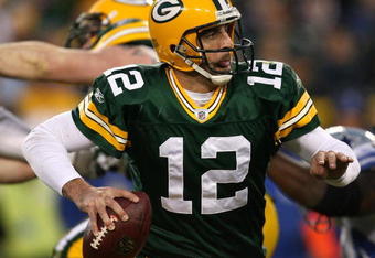 GREEN BAY, WI - NOVEMBER 15: Aaron Rodgers #12 of the Green Bay Packers looks for a receiver against the Dallas Cowboys at Lambeau Field on November 15, 2009 in Green Bay, Wisconsin. The Packers defeated the Cowboys 17-7. (Photo by Jonathan Daniel/Getty Images)