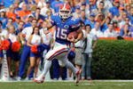 GAINESVILLE, FL - NOVEMBER 21: Quarterback Tim Tebow #15 of the Florida Gators rushes upfield against the Florida International University Golden Panthers, November 21, 2009 at Ben Hill Griffin Stadium in Gainesville, Florida.  (Photo by Al Messerschmidt/Getty Images)