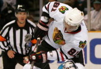 SAN JOSE, CA - NOVEMBER 25:  Marian Hossa #81 of the Chicago Blackhawks is stopped by goalie Evgeni Nabokov #20 of the San Jose Sharks during their game at HP Pavilion on November 25, 2009 in San Jose, California.  (Photo by Ezra Shaw/Getty Images)