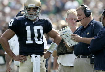 SOUTH BEND, IN - SEPTEMBER 9:  Brady Quinn #10 of the Notre Dame Fighting Irish talks with head coach Charlie Weis during a game against the Penn State Nittany Lions on September 9, 2006 at Notre Dame Stadium in South Bend, Indiana. Notre Dame won the game 41-17. (Photo By Gregory Shamus/Getty Images)  