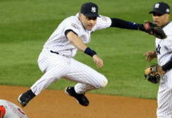NEW YORK - NOVEMBER 04:  Derek Jeter #2 of the New York Yankees turns a successful double play over Shane Victorino #8 of the Philadelphia Phillies in the top of the first inning of Game Six of the 2009 MLB World Series at Yankee Stadium on November 4, 2009 in the Bronx borough of New York City. The Yankees won 7-3 to win the series 4 games to 2. (Photo by Al Bello/Getty Images)