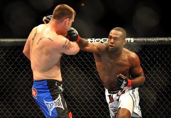 LAS VEGAS - JULY 11:  (R-L) Jon Jones connects with a right punch on Jake O'Brein during their light heavyweight bout during UFC 100 on July 11, 2009 in Las Vegas, Nevada. Jones defeated O'Brein by second round tapout.  (Photo by Jon Kopaloff/Getty Images)