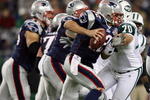 FOXBORO, MA - NOVEMBER 22:  Tom Brady #12 of the New England Patriots scrambles as Mike DeVito #70 of the New York Jets pressures on November 22, 2009 at Gillette Stadium in Foxboro, Massachusetts. The Patriots defeated the Jets 31-14.  (Photo by Elsa/Getty Images)