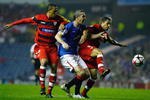 GLASGOW, SCOTLAND - SEPTEMBER 29:  David Weir of Rangers tackles Luis Fabiano and Adriano of Sevilla during the UEFA Champions League Group G match between Rangers and Sevilla at Ibrox Stadium on September 29, 2009 in Glasgow, Scotland.  (Photo by Jeff J Mitchell/Getty Images)
