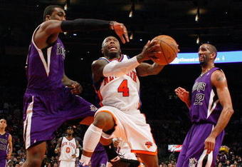 NEW YORK - MARCH 20:  Nate Robinson #4 of the New York Knicks lays the ball up against Donte Greene #20 of the Sacramento Kingson March 20, 2009 at Madison Square Garden in New York City. NOTE TO USER: User expressly acknowledges and agrees that, by downloading and or using this photograph, User is consenting to the terms and conditions of the Getty Images License Agreement.  (Photo by Nick Laham/Getty Images)