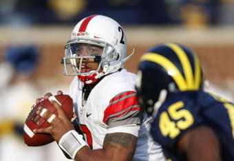 ANN ARBOR, MI - NOVEMBER 21:  Terrelle Pryor #2 of the Ohio State Buckeyes looks to throw a fourth quarter pass behind Obi Ezeh #45 of the Michigan Wolverines on November 21, 2009 at Michigan Stadium in Ann Arbor, Michigan. Ohio State won the game 21-10. (Photo by Gregory Shamus/Getty Images)