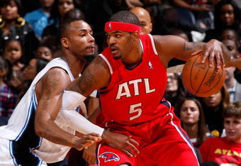 ATLANTA - NOVEMBER 26:  Josh Smith #5 of the Atlanta Hawks drives against Rashard Lewis #9 of the Orlando Magic at Philips Arena on November 26, 2009 in Atlanta, Georgia.  NOTE TO USER: User expressly acknowledges and agrees that, by downloading and/or using this Photograph, user is consenting to the terms and conditions of the Getty Images License Agreement. (Photo by Kevin C. Cox/Getty Images)