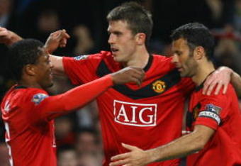 MANCHESTER, ENGLAND - NOVEMBER 21:  Michael Carrick of Manchester United celebrates scoring his team's second goal with team mates Patrice Evra and Ryan Giggs (R) during the Barclays Premier League match between Manchester United and Everton at Old Trafford on November 21, 2009 in Manchester, England.  (Photo by Alex Livesey/Getty Images)
