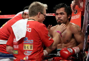 LAS VEGAS - NOVEMBER 14:  Manny Pacquiao sits in his corner between rounds with trainer Freddie Roach against Miguel Cotto during their WBO welterweight title fight at the MGM Grand Garden Arena on November 14, 2009 in Las Vegas, Nevada.  (Photo by Al Bello/Getty Images)