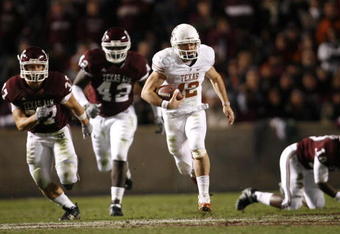 COLLEGE STATION, TX - NOVEMBER 26: Quarterback Colt McCoy #12 of the Texas Longhorns scrambles away from the Texas A&M Aggies defense to score a touchdown in the first half at Kyle Field on November 26, 2009 in College Station, Texas.  (Photo by Aaron M. Sprecher/Getty Images)