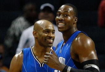 CHARLOTTE, NC - NOVEMBER 10:  Teammates Vince Carter #15 and Dwight Howard #12 of the Orlando Magic smile as they look over at the bench against the Charlotte Bobcats during their game at Time Warner Cable Arena on November 10, 2009 in Charlotte, North Carolina.  (Photo by Streeter Lecka/Getty Images)