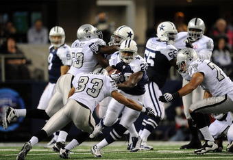 ARLINGTON, TX - NOVEMBER 26:  Running back Felix Jones #28 of the Dallas Cowboys runs the ball against Tyvon Branch #33 of the Oakland Raiders at Cowboys Stadium on November 26, 2009 in Arlington, Texas.  (Photo by Ronald Martinez/Getty Images)
