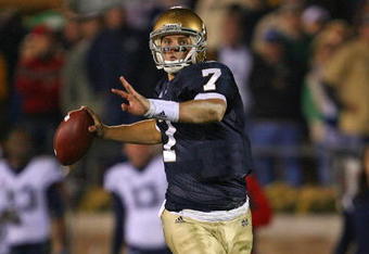 SOUTH BEND, IN - NOVEMBER 21: Jimmy Clausen #7 of the Notre Dame Fighting Irish looks for a receiver in the first overtime period against the Univeristy of Connecticut Huskies at Notre Dame Stadium on November 21, 2009 in South Bend, Indiana. Connecticut defeated Notre Dame 33-30 in double overtime. (Photo by Jonathan Daniel/Getty Images)