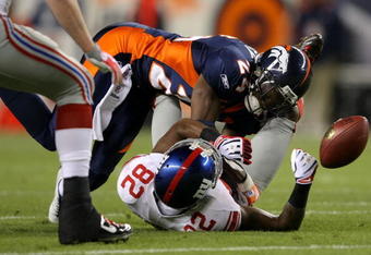 DENVER - NOVEMBER 26:  Wide receiver Mario Manningham #82 of the New York Giants is unable to make a reception as he is hit by Champ Bailey #24 of the Denver Broncos during NFL action at Invesco Field at Mile High on November 26, 2009 in Denver, Colorado.  (Photo by Doug Pensinger/Getty Images)