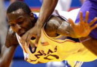 LAWRENCE, KS - NOVEMBER 27:  Tyshawn Taylor #10 of the Kansas Jayhawks dives to try to steal the ball from Zach Bailey #42 of the Tennessee Tech Golden Eagles during the game on November 27, 2009 at Allen Fieldhouse in Lawrence, Kansas.  (Photo by Jamie Squire/Getty Images)