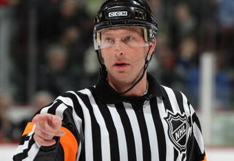 VANCOUVER, CANADA - DECEMBER 17:  NHL Referee Brad Meier makes a pointing gesture during the NHL game between the Vancouver Canucks and the Edmonton Oilers at General Motors Place on December 17, 2005 in Vancouver, British Columbia, Canada.  The Oilers defeated the Canucks 5-4 in overtime. (Photo by Jeff Vinnick/Getty Images)