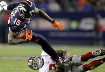 DENVER - NOVEMBER 26:  Wide receiver Brandon Marshall #15 of the Denver Broncos makes a pass reception and is tackled by Terrell Thomas #24 of the New York Giants during NFL action at Invesco Field at Mile High on November 26, 2009 in Denver, Colorado.  (Photo by Doug Pensinger/Getty Images)