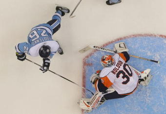 UNIONDALE, NY - NOVEMBER 27: Ruslan Fedotenko #26 of the Pittsburgh Penguins is stopped by Dwayne Roloson #30 of the New York Islanders at the Nassau Coliseum on November 27, 2009 in Uniondale, New York. The Islanders defeated the Penguins 3-2.  (Photo by Bruce Bennett/Getty Images)