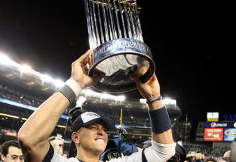 NEW YORK - NOVEMBER 04:  Alex Rodriguez #13 of the New York Yankees celebrates with the trophy after their 7-3 win  against the Philadelphia Phillies in Game Six of the 2009 MLB World Series at Yankee Stadium on November 4, 2009 in the Bronx borough of New York City.  (Photo by Jed Jacobsohn/Getty Images)