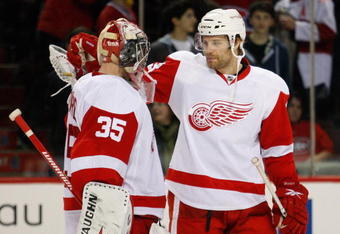 MONTREAL- NOVEMBER 21:  Brad Stuart #23 celebrates with Jimmy Howard #35 of the Detroit Red Wings after defeating the Montreal Canadiens 3-2 in shootouts in the NHL game on November 21, 2009 at the Bell Centre in Montreal, Quebec, Canada.  The Red Wings defeated the Canadiens 3-2 in a shootout.  (Photo by Richard Wolowicz/Getty Images)