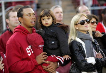 PALO ALTO, CA - NOVEMBER 21:  Honorary Standford Cardinal captain Tiger Woods his daugher, Sam, and wife, Elin Nordegren, stand on the sidelines before the Cardinal game against the California Bears at Stanford Stadium on November 21, 2009 in Palo Alto, California.  (Photo by Ezra Shaw/Getty Images)