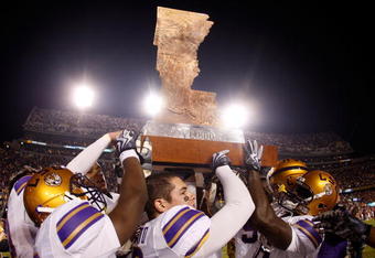 BATON ROUGE, LA - NOVEMBER 28:  Members of the LSU Tigers celebrate with 'The Boot' trophy after defeating the Arkansas Razorbacks 33-30 in overtime at Tiger Stadium on November 28, 2009 in Baton Rouge, Louisiana.  (Photo by Chris Graythen/Getty Images)