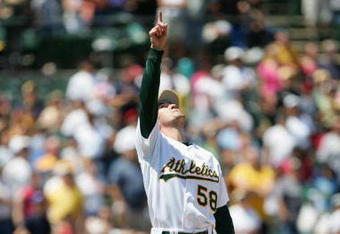 OAKLAND, CA - JUNE 18:  Pitcher Justin Duchscherer #58 of the Oakland Athletics points to the sky during the game against the Philadelphia Phillies at McAfee Coliseum on June 18, 2005 in Oakland, California.  The Athletics won 2-1.  (Photo by Jed Jacobsohn/Getty Images)