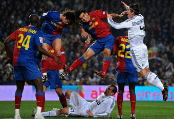 BARCELONA, SPAIN - DECEMBER 13:  Rafael Marquez (2nd R) and Carles Puyol (2nd L) of Barcelona fight for the ball with Sergio Ramos (R) of Real Madrid as Ramos his teammate Christoph Metzelder (Bottem C) lays on the pitch during the La Liga match between Barcelona and Real Madrid at the Camp Nou Stadium on December 13, 2008 in Barcelona, Spain.  (Photo by Jasper Juinen/Getty Images)