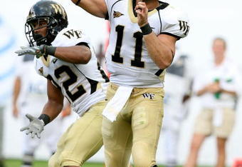 MIAMI - OCTOBER 25:  Quarterback Riley Skinner #11 of the Wake Forest Demon Decons throws a pass against the Miami Hurricanes at Dolphin Stadium on October 25, 2008 in Miami, Florida.  (Photo by Doug Benc/Getty Images)