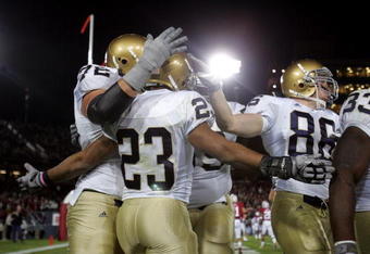 PALO ALTO, CA - NOVEMBER 28:  Golden Tate #23 of the Notre Dame Fighting Irish is congratulated by teammates after he scored a touchdown during their game against the Stanford Cardinal at Stanford Stadium on November 28, 2009 in Palo Alto, California.  (Photo by Ezra Shaw/Getty Images)