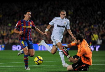 BARCELONA, SPAIN - NOVEMBER 29:  Xavier Hernandez (L) of FC Barcelona tries to score against Pepe and goalkeeper Iker Casillas (R) of Real Madrid during the La Liga match between Barcelona and Real Madrid at the Camp Nou Stadium on November 29, 2009 in Barcelona, Spain.  (Photo by Jasper Juinen/Getty Images)