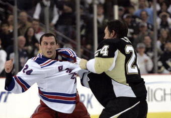 PITTSBURGH, PA - NOVEMBER 28:  Matt Cooke #24 of the Pittsburgh Penguins mixes it up with Ryan Callahan #24 of the New York Rangers in the third period at Mellon Arena on November 28, 2009 in Pittsburgh, Pennsylvania.  Penguins won 8-3.  (Photo by Justin K. Aller/Getty Images)