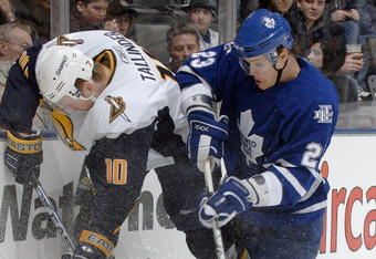 TORONTO - MARCH 3: Henrik Tallinder #10 of the Buffalo Sabres and Alexei Ponikarovsky #23 of the Toronto Maple Leafs battle for the puck during the NHL game at Air Canada Centre March 3, 2007 in Toronto, Ontario, Canada. (Photo by Dave Abel/Getty Images)