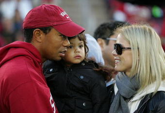 PALO ALTO, CA - NOVEMBER 21:  Honorary Standford Cardinal captain Tiger Woods holds his daugher, Sam, and speaks to his wife, Elin Nordegren, on the sidelines before the Cardinal game against the California Bears at Stanford Stadium on November 21, 2009 in Palo Alto, California.  (Photo by Ezra Shaw/Getty Images)