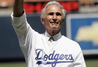 LOS ANGELES - AUGUST 28: Hall of Fame pitcher Sandy Koufax of the Los Angeles Dodgers waves to the crowd during ceremonies honoring memebers of the 1955 World Champion Dodgers before the game with the Houston Astros on August 28, 2005 at Dodger Stadium in Los Angeles, California. The Dodgers won 1-0. (Photo by Stephen Dunn /Getty Images)