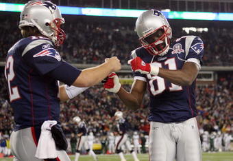 FOXBORO, MA - NOVEMBER 22:  Randy Moss #81 and Tom Brady #12 of the New England Patriots celebrate Laurence Maroney's touchdown in the second quarter against the New York Jets on November 22, 2009 at Gillette Stadium in Foxboro, Massachusetts.  (Photo by Elsa/Getty Images)