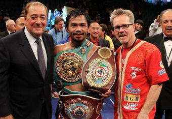 LAS VEGAS - NOVEMBER 14:  (L-R) Promoter Bob Arum, boxer Manny Pacquiao and trainer Freddie Roach celebrate Pacquiao's 12 round TKO victory against Miguel Cotto during their WBO welterweight title fight at the MGM Grand Garden Arena on November 14, 2009 in Las Vegas, Nevada.  (Photo by Al Bello/Getty Images)