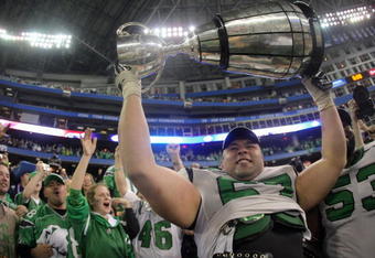 TORONTO - NOVEMBER 25:  Mike Abou-Mechrek #67 of the Saskatchewan Rough Riders hoists the Grey Cup in celebration of a 23-19 victory over the Winnipeg Blue Bombers during the 95th Grey Cup on November 25, 2007 at the Rogers Centre in Toronto, Ontario, Canada.  (Photo by Harry How/Getty Images)