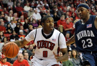 LAS VEGAS - NOVEMBER 18:  Oscar Bellfield #0 of the UNLV Rebels drives around Armon Johnson #23 of the Nevada Wolf Pack during their game at the Thomas & Mack Center on November 18, 2009 in Las Vegas, Nevada. UNLV won 88-75.  (Photo by Ethan Miller/Getty Images)
