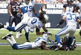 HOUSTON - NOVEMBER 29:  Wide receiver Andre Jophnson #80 of the Houston Texans is tackled by defensive back Jacob Lacey #27 and linebacker Philip Wheeler #50 of the Indianapolis Colts at Reliant Stadium on November 29, 2009 in Houston, Texas.  (Photo by Bob Levey/Getty Images)