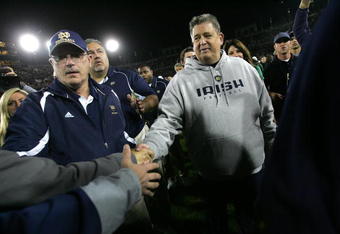 PALO ALTO, CA - NOVEMBER 28:  Notre Dame head coach Charlie Weis shakes hands with fans as he walks off the field after their loss to the Stanford Cardinal at Stanford Stadium on November 28, 2009 in Palo Alto, California.  (Photo by Ezra Shaw/Getty Images)