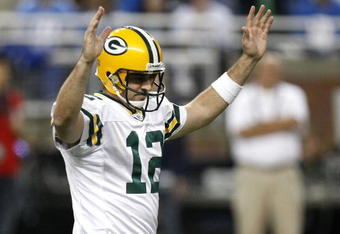 DETROIT , MI - NOVEMBER 26: Aaron Rodgers #12 of the Green Bay Packers reacts after throwing a second quarter touchdown against the Detroit Lions on November 26, 2009 at Ford Field in Detroit, Michigan.  (Photo by Gregory Shamus/Getty Images)
