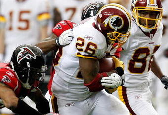 ATLANTA - NOVEMBER 08:  Clinton Portis #26 of the Washington Redskins rushes upfield against Thomas DeCoud #28 of the Atlanta Falcons at Georgia Dome on November 8, 2009 in Atlanta, Georgia.  (Photo by Kevin C. Cox/Getty Images)