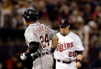 MINNEAPOLIS - OCTOBER 06:  Miguel Cabrera #24 of the Detroit Tigers rounds the bases after hitting a home run as Matt Tolbert #20 of the Minnesota Twins looks on during the 3rd inning of the American League Tiebreaker game on October 6, 2009 at Hubert H. Humphrey Metrodome in Minneapolis, Minnesota.  (Photo by Jamie Squire/Getty Images)